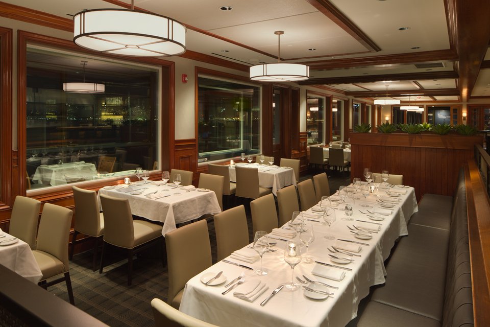 White-tablecloth dining room with harbor views.